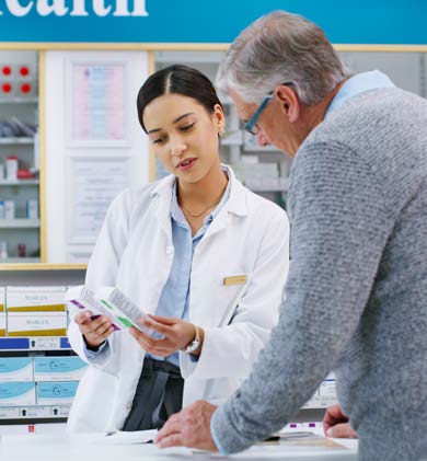 A pharmacist reviews drug information with a customer.