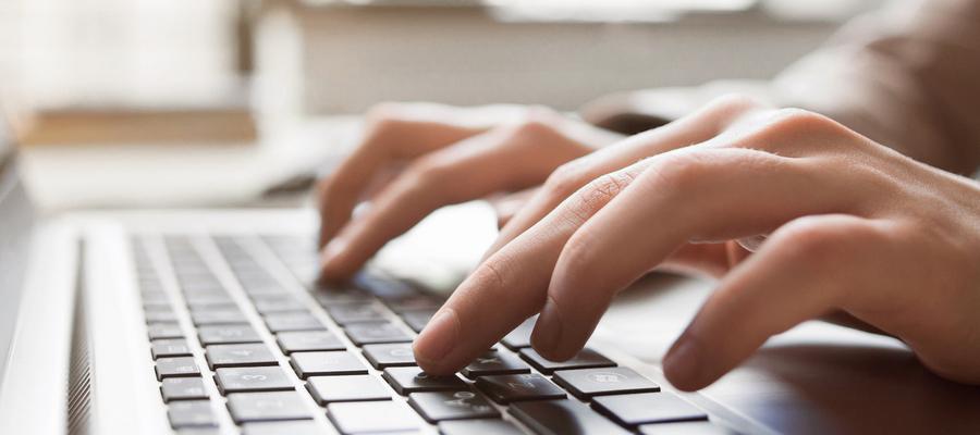 Fingers type on a keyboard